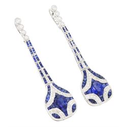 Pair of platinum sapphire and diamond pendant earrings, each stud milgrain set with a single oval cut sapphire, surrounded by calibre cut sapphires and single cut diamonds, suspending from six graduating articulated panels, to four single cut diamonds, total sapphire weight approx 3.80 carat, total diamond weight approx 0.80 carat