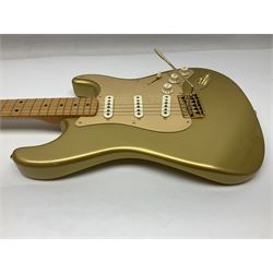 Fender Stratocaster 50th Anniversary 2004 metallic gold electric guitar; serial no.MZ4116369; L98cm; in Spider fitted case with owners manual and other paperwork, strap and belt buckle etc