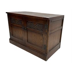 Mid to late 20th century oak cupboard, rectangular top over two doors carved with lunettes, on plinth base