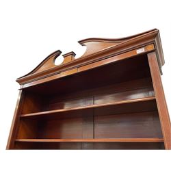 19th century inlaid mahogany bookcase on cupboard, swan neck pediment over three adjustable shelves, the base fitted with two drawers over two panelled cupboard doors, the facias inlaid with ornate urns surrounded by foliate