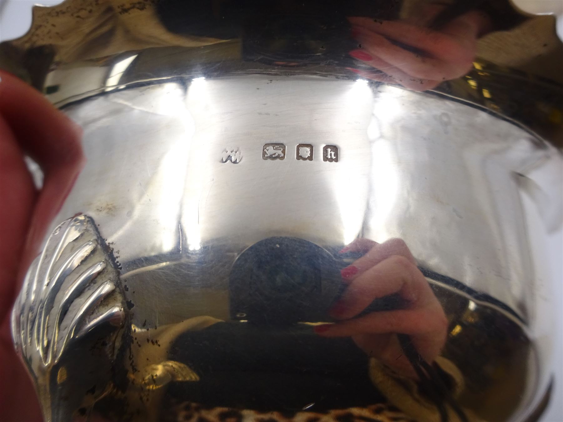 1920s three piece silver tea service, comprising teapot, with ebonised wooden handle and finial, milk jug and open sucrier, all of circular form, with shaped rims, and upon three hoof feet, hallmarked Wakely & Wheeler, London 1922, teapot H19cm