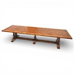 Country House 12' oak and fruitwood refectory dining table, the substantial rectangular plank top with cleated ends and chamfered edge, raised on twin trestle end square tapering and turned baluster supports with sledge feet and chamfered united by a long stretcher rail
