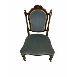 Victorian walnut nursing chair, the cresting rail carved with scrolled foliage, turned supports