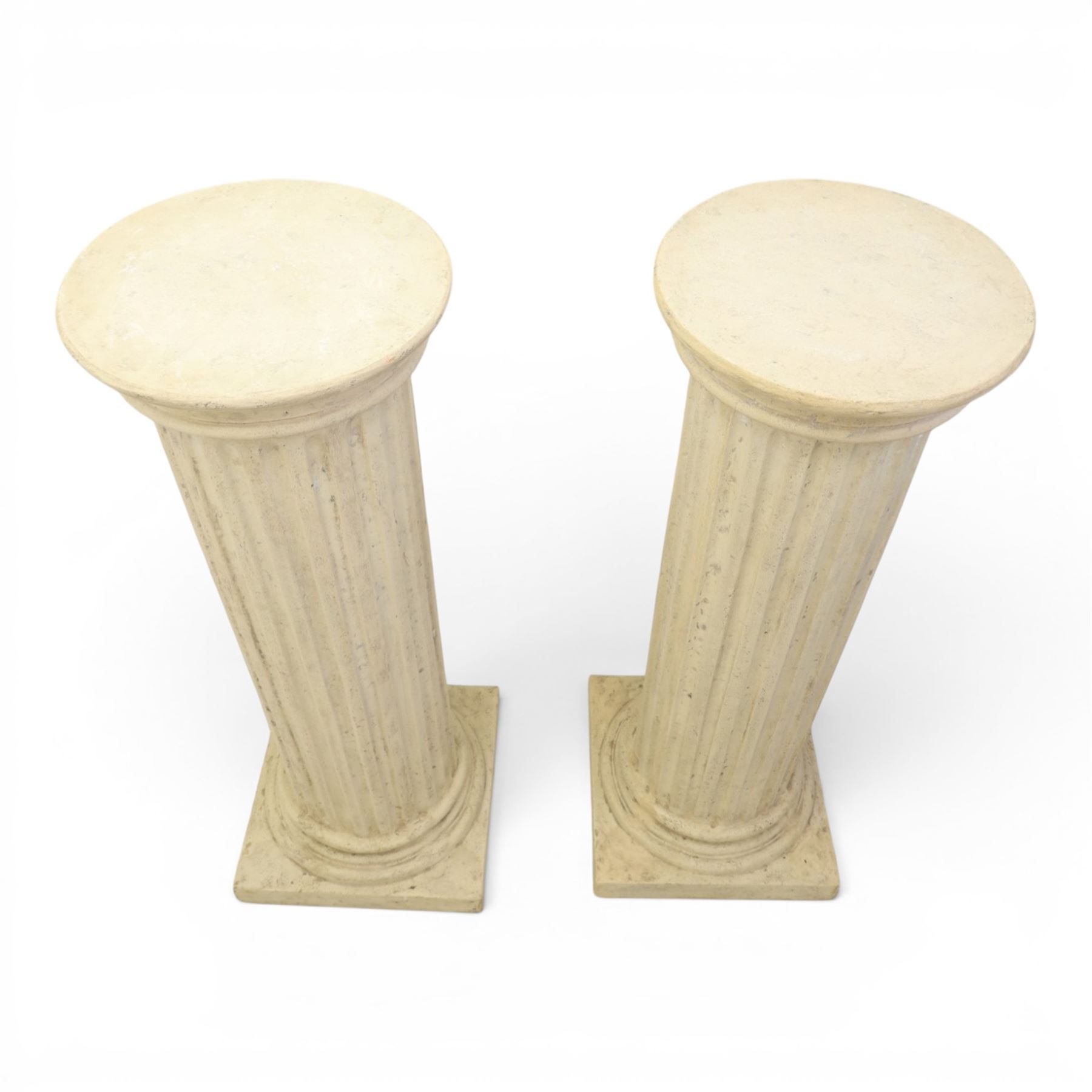 Pair of Regency style composite stone column pedestals, with fluted cylindrical columns and moulded capitals and bases, on square plinths