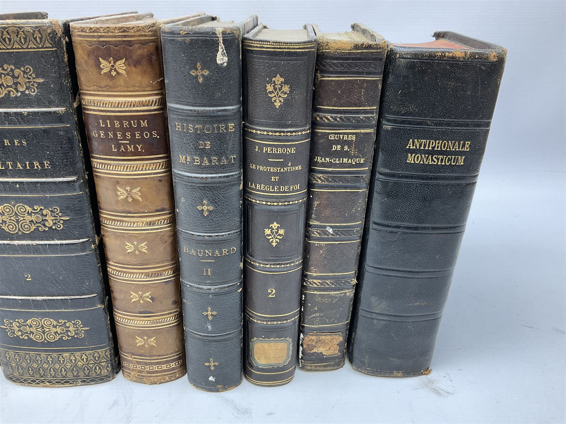 Eighteen 19th century leather bound books including Oeuvres Completes De Voltaire. 1827 Paris. Two volumes; Oeuvres De Pierre Corneille. 1892 Paris; Commentarium in Librum Geneseos Scripsit Thomas Josephus Lamy. 1883 Mechliniae; etc (18)