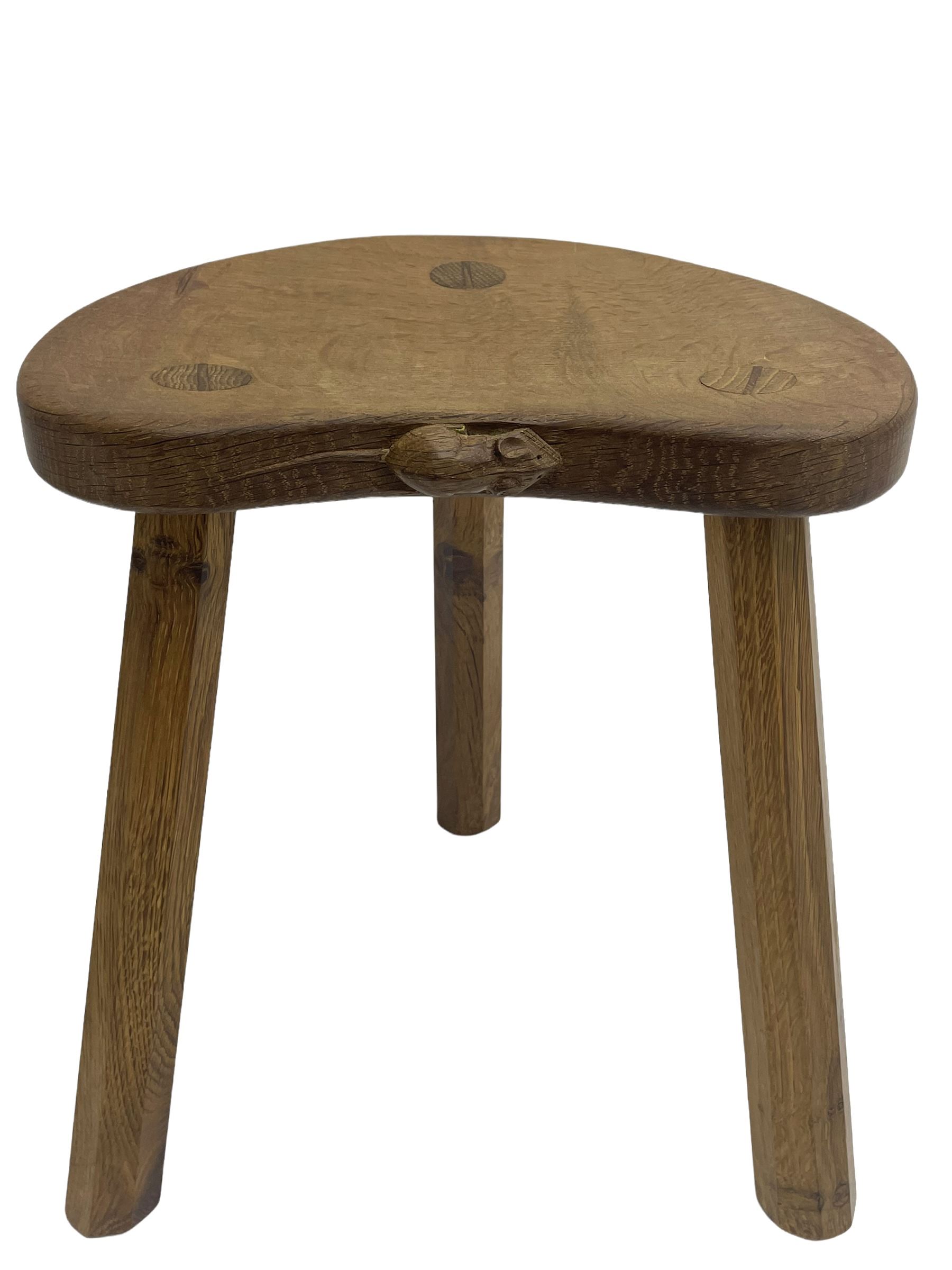 'Mouseman' oak three-legged stool, kidney shaped dished seat carved with mouse signature to edge, by Robert Thomas of Kilburn