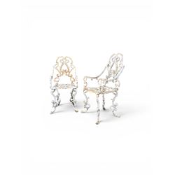 Pair of Victorian cast iron garden chairs, the ornate pierced back of scrolling foliate de...