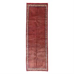 West Persian Saraband (Boteh-Mir) runner madder-red field densely decorated with repeating...