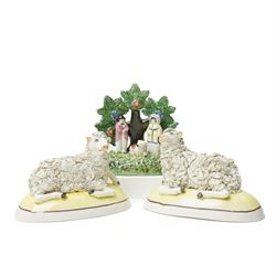 Pair of 19th century Staffordshire sheep, W13cm; together with a pearlware bocage group, H12cm (3)