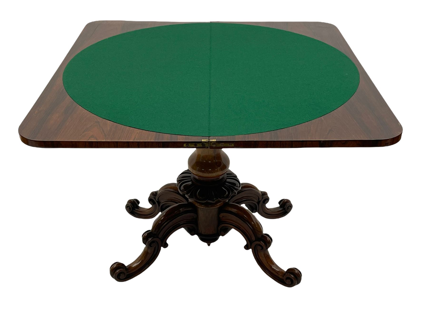 Victorian figured rosewood card table, fold-over swivel top with circular baize lining, moulded frieze with stylised flower head carving to corners, turned column with egg and dart decoration, on quadruple splayed c-scroll carved supports, with brass castors