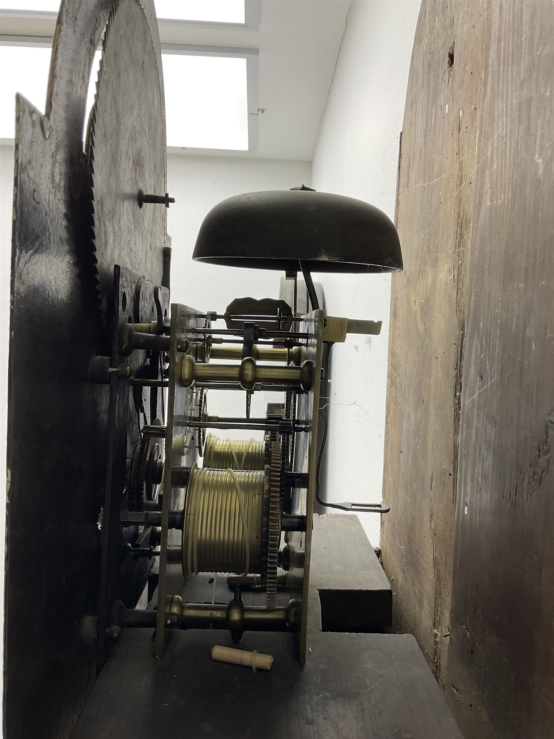 W Sargent of Boston (Lincs) - late 18th century oak cased 8-day longcase clock, with a deep swans necked pediment and brass paterie, break arch hood door with a dog tooth moulding above and detached reeded pilasters with brass capitals, trunk with canted corners and recessed pilasters, long trunk door with a pointed top and central lock escutcheon, on a shortened plinth with applied skirting, painted dial with a moon disc to the arch and spandrels with depictions of fruit within gesso borders, Roman numerals with Arabic five minutes and matching steel hands, date aperture and seconds dial, dial pinned via a false plate to a rack striking movement, striking the hours on a cast bell. With pendulum and weights.