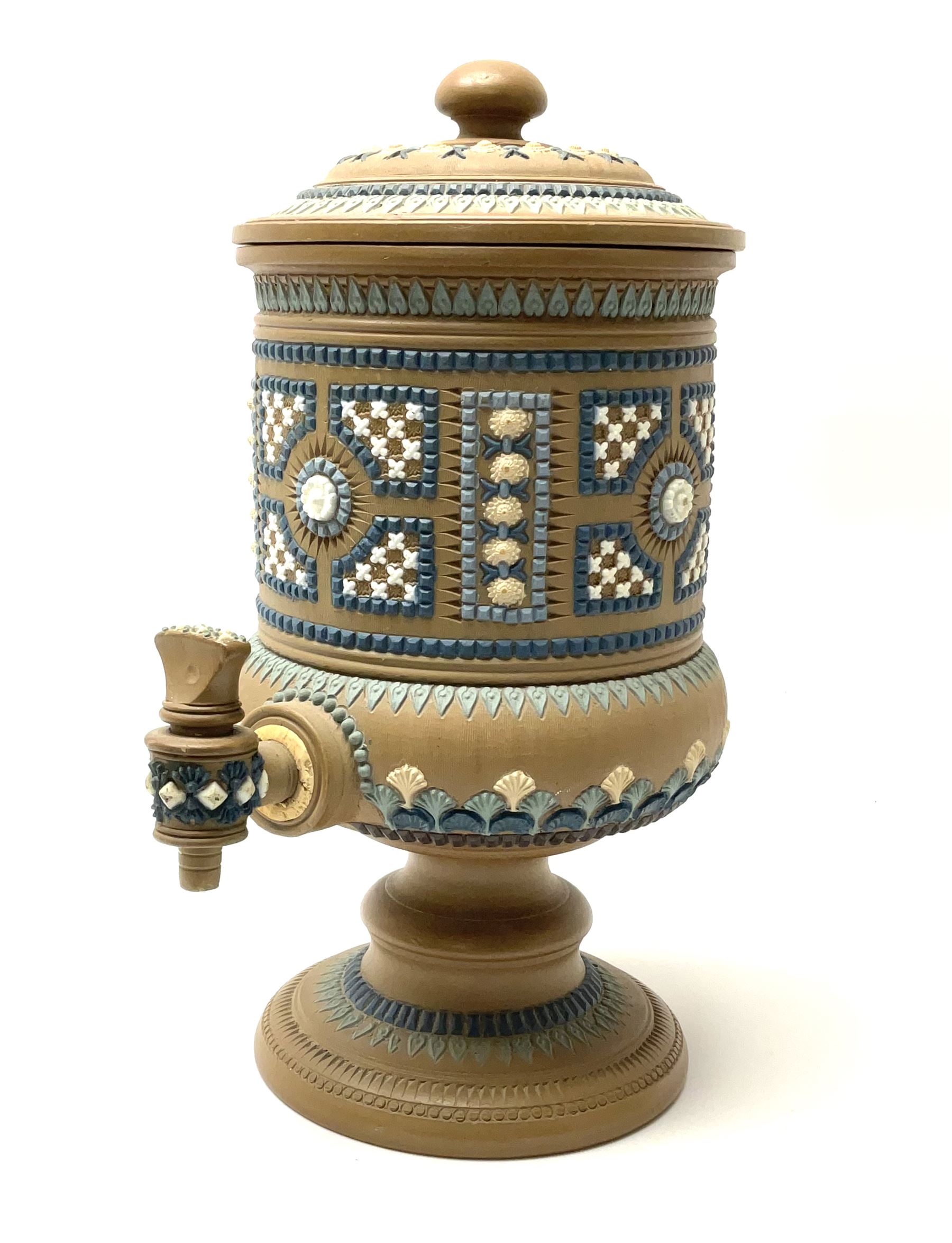 A late 19th century Doulton Lambeth stoneware water filter with original spigot, decorated with relief moulded foliate bands, with impressed marks and monogrammed for Laura Gooderham beneath, H34cm. 