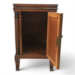  Pair of Regency mahogany bedside cabinets, rectangular top above a central cupboard door with flame mahogany veneer, flanked by spirally turned column uprights, raised on shaped supports