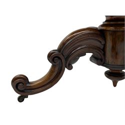 Victorian figured rosewood card table, fold-over swivel top with circular baize lining, moulded frieze with stylised flower head carving to corners, turned column with egg and dart decoration, on quadruple splayed c-scroll carved supports, with brass castors