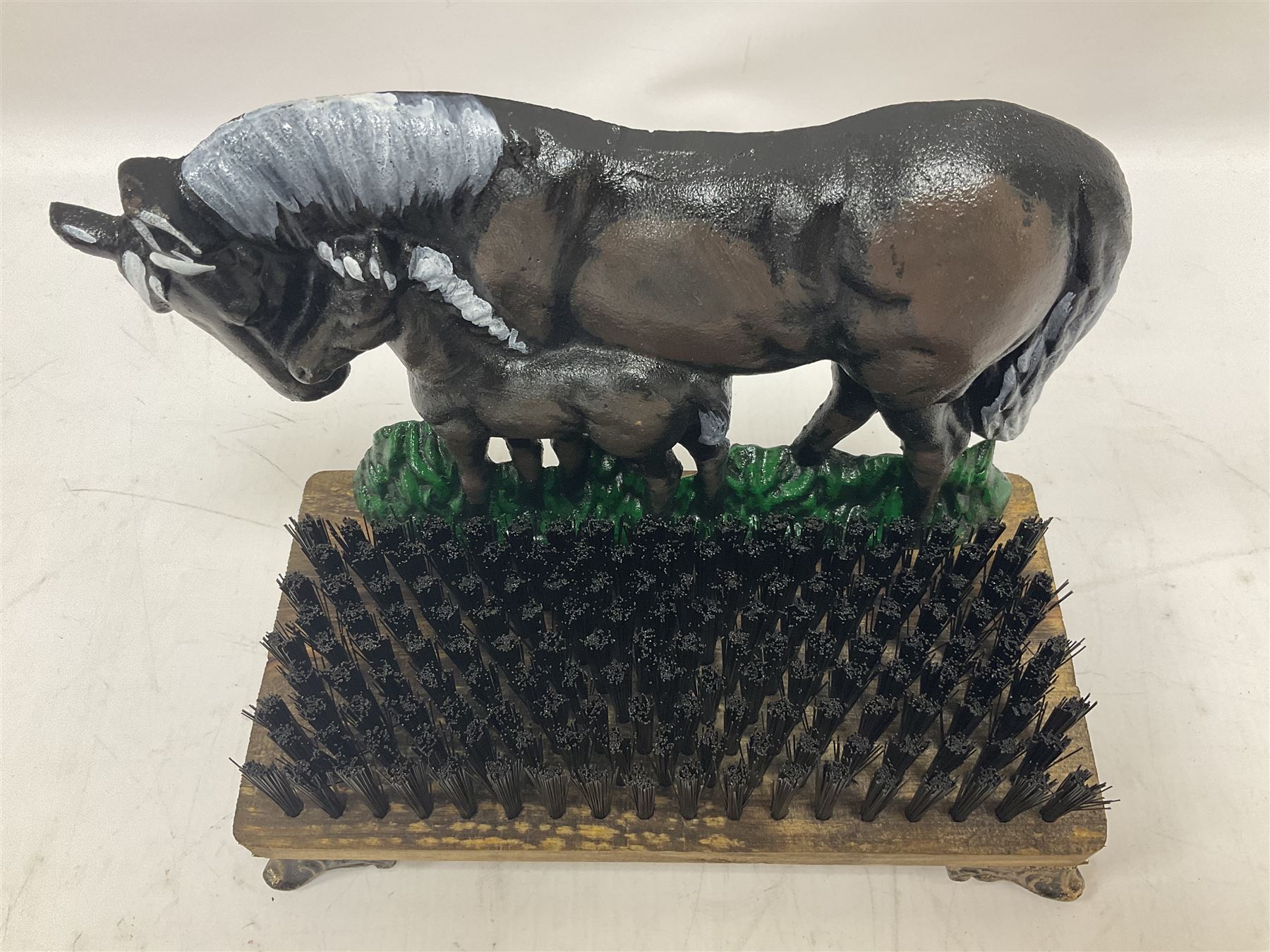 Cast iron horse and foal boot brush on wooden base, H25 cm