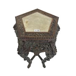 Early 20th century Chinese carved hardwood jardinière stand, the bead carved pentagon top with marble inset, carved and pierced with dragons and scrolling motifs, five shaped supports joined by stretches carved with flower head motifs