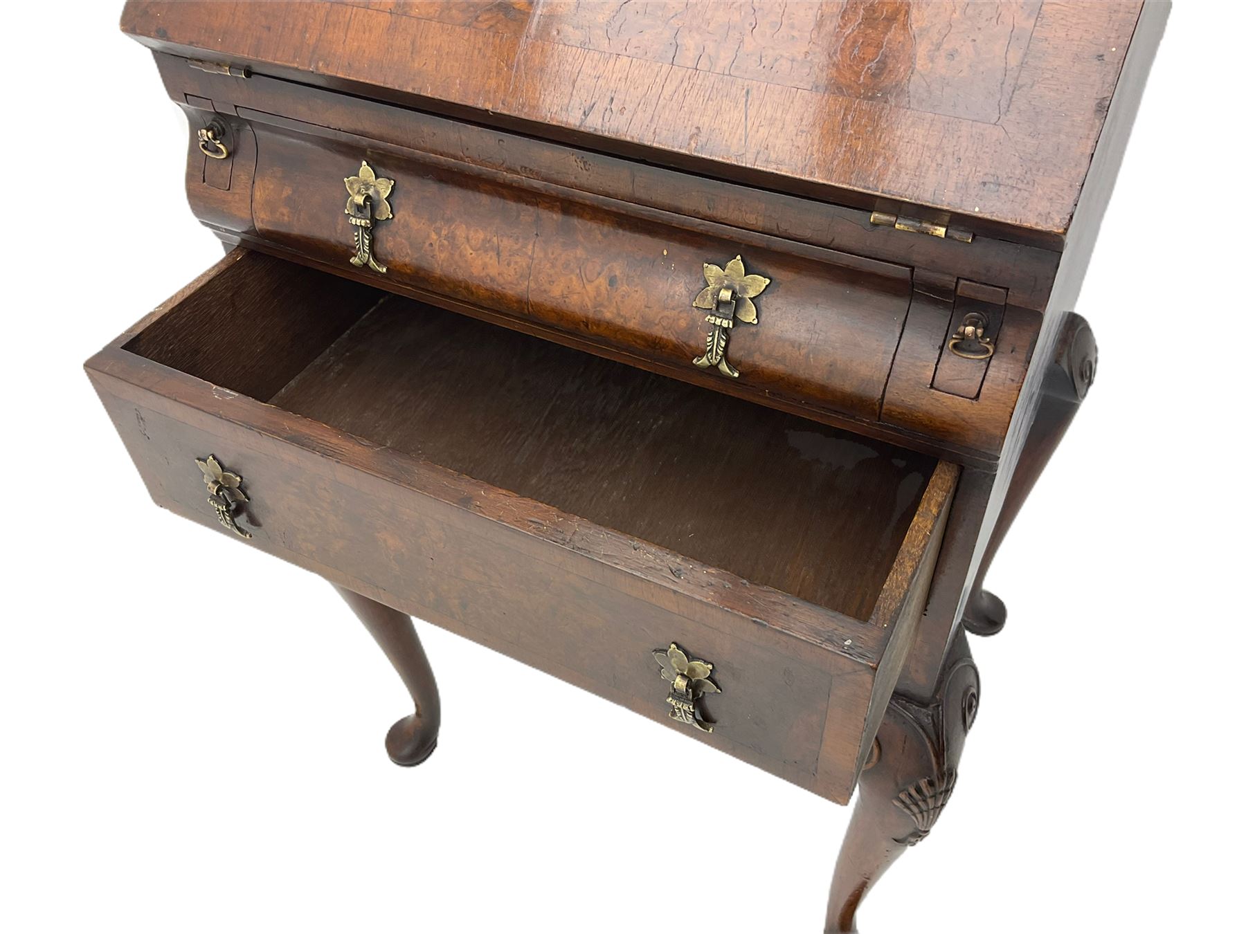 Small early 20th century Queen Anne style bookcase on bureau secretaire, the moulded arched pediment over mirrored door in shaped frame, the bureau fitted with fall front enclosing curved fitted interior, cushion moulded drawer over single drawer, on scroll and shell carved cabriole supports