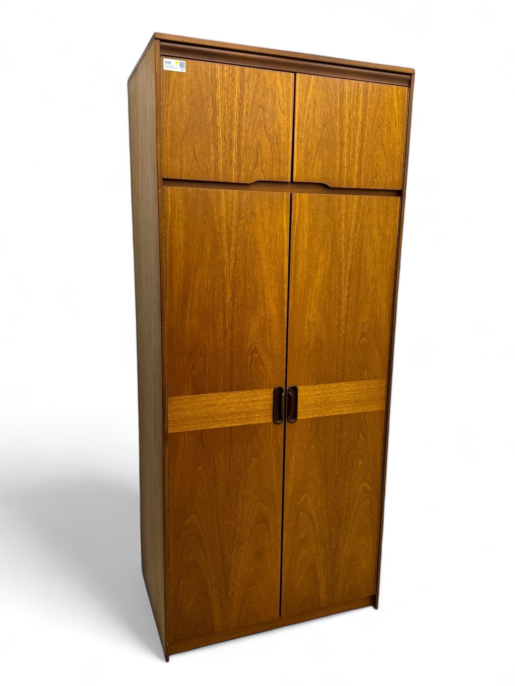 William Lawrence - mid-20th century teak double wardrobe, upper storage section over twin doors featuring recessed handles and contrasting horizontal panel, enclosing a hanging rail compartment, on plinth base with concealed castors