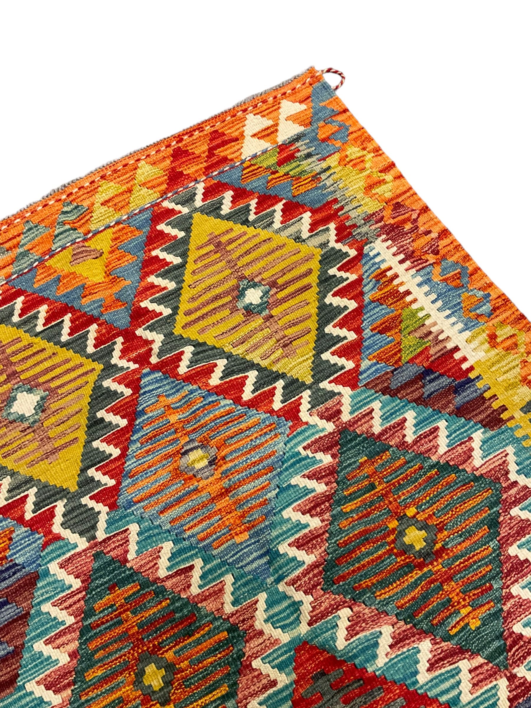 Chobi Kilim rug, multi-coloured ground in oranges, blues and greens, overall geometric design 