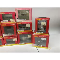 Hornby 'N' gauge - eighteen Lyddle End trackside buildings including The Old Toll House, Electricity Sub Station, Teesdale bakery, Mason's Arms Pub, various shops and hairdressers, farm buildings, Clock Tower etc; all boxed; and five Lyddle End blister pack cards of trackside accessories including Lamp Huts, Tractors, War memorial etc (23)