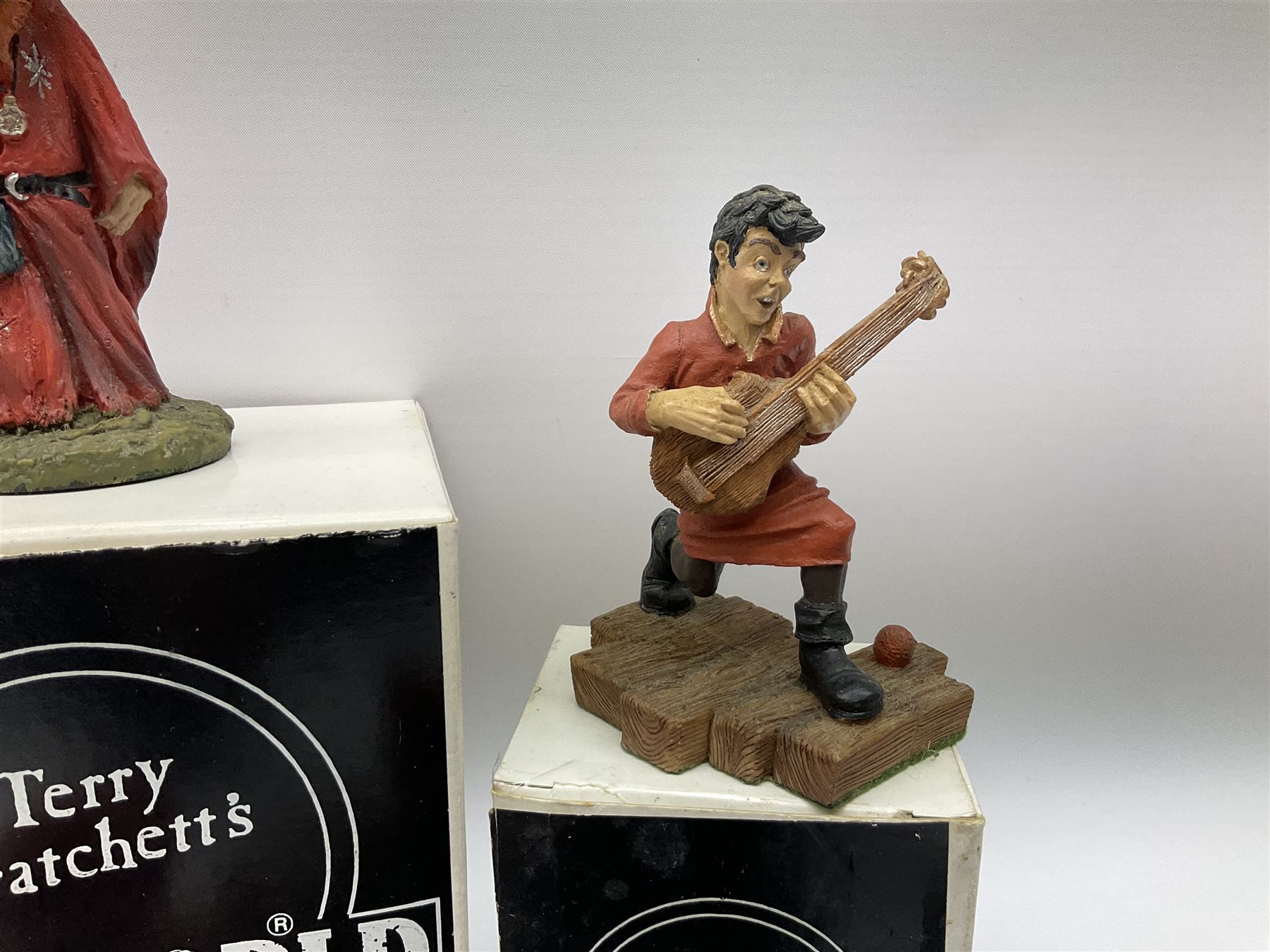 Terry Pratchett Discworld figures, designed by Clarecraft, comprising Rincewind and Luggage bookend DW41, Imp Y Celyn, DW81, C.M.O.T Dibbler, DW35, Rincewind, DW01 and Susan Sto Helit, boxed, DW77