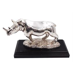 Filled silver model of a rhinoceros by Afrisilver, upon lacquered wooden base, H11.5cm