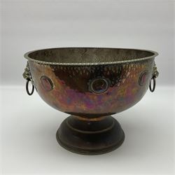 Copper pedestal punch bowl, with planished decoration with twin lion mask and ring handles and applied coins, H18cm