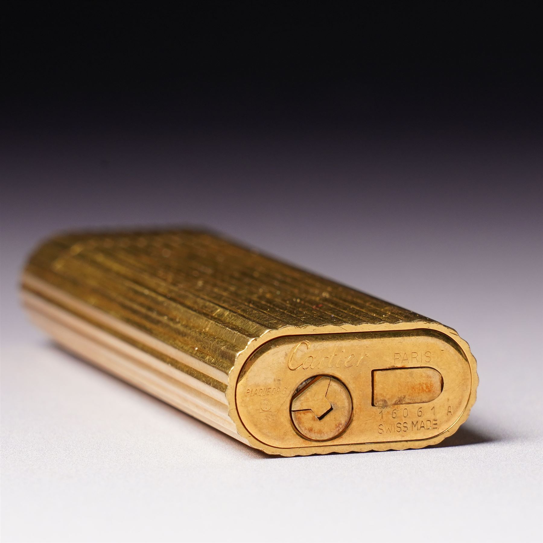 Vintage Cartier gold plated lighter with rounded edges and textured finish marked 'Cartier, Paris No16061A' and inscribed with initials in original Cartier case 