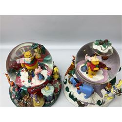 Six Disney Winnie the Pooh Christmas snow globes, comprising large Mr Christmas Holiday Snowfall, An Enchanted Christmas, It's A Small World Christmas 1994,  Tree Trimming, 1995 Christmas At Our House and Christmas Band Concert, together with Mr Christmas Holiday Go Round, all with boxes (7)