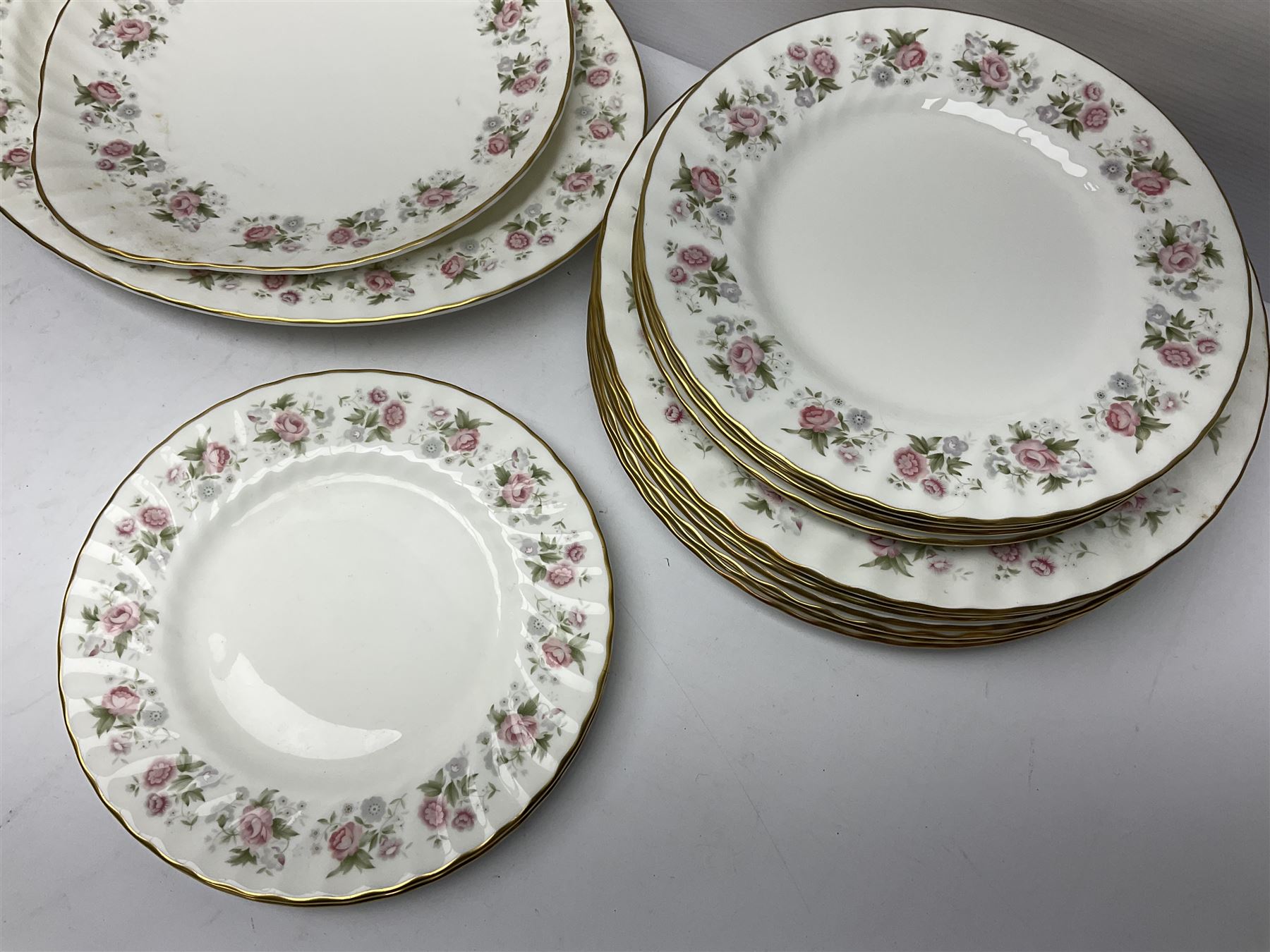 Minton Spring Bouquet pattern dinner and tea service, comprising dinner plates, twin handled tureens with covers, meat platter, teapot, milk jug, sugar bowl with cover, tea cups and saucers, bowls, cake plate, side plates, dessert plates, etc all with printed mark beneath (82)