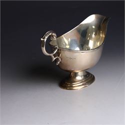 1930s silver sauce boat, of typical form with acanthus capped flying C scroll handle and upon stepped oval foot, hallmarked William Hutton & Sons Ltd, Sheffield 1938, height including handle H10cm