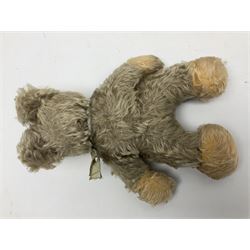 Steiff teddy bear with golden plush body, revolving head, applied eyes, vertically stitched nose and mouth and jointed limbs; button to left ear H26cm; and two other Steiff teddy bears, each with open mouth and button with tag to left ear (3)
