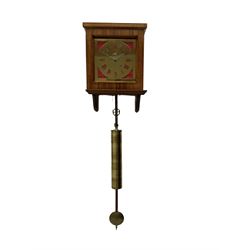 Eight-day weight driven wall clock to the constructional design of John Wilding, with a brass sheet dial and fretted Roman numerals, pierced steel hands and seconds hand, brass movement plates with steel pillars, lantern pinions and brass wheels, mahogany veneered case with a sliding hood and wall bracket, with pulley, brass cased weight and pendulum.
The movement was designed for a passing strike which has been disconnected, the maker must have intended to use Henry Wards hourly striking mechanism which John Wild fitted to his movement. Many of the components are present but not fitted to the movement. With a copy of John Wildings construction book “How to make a Weight Driven Eight Day wall clock”
