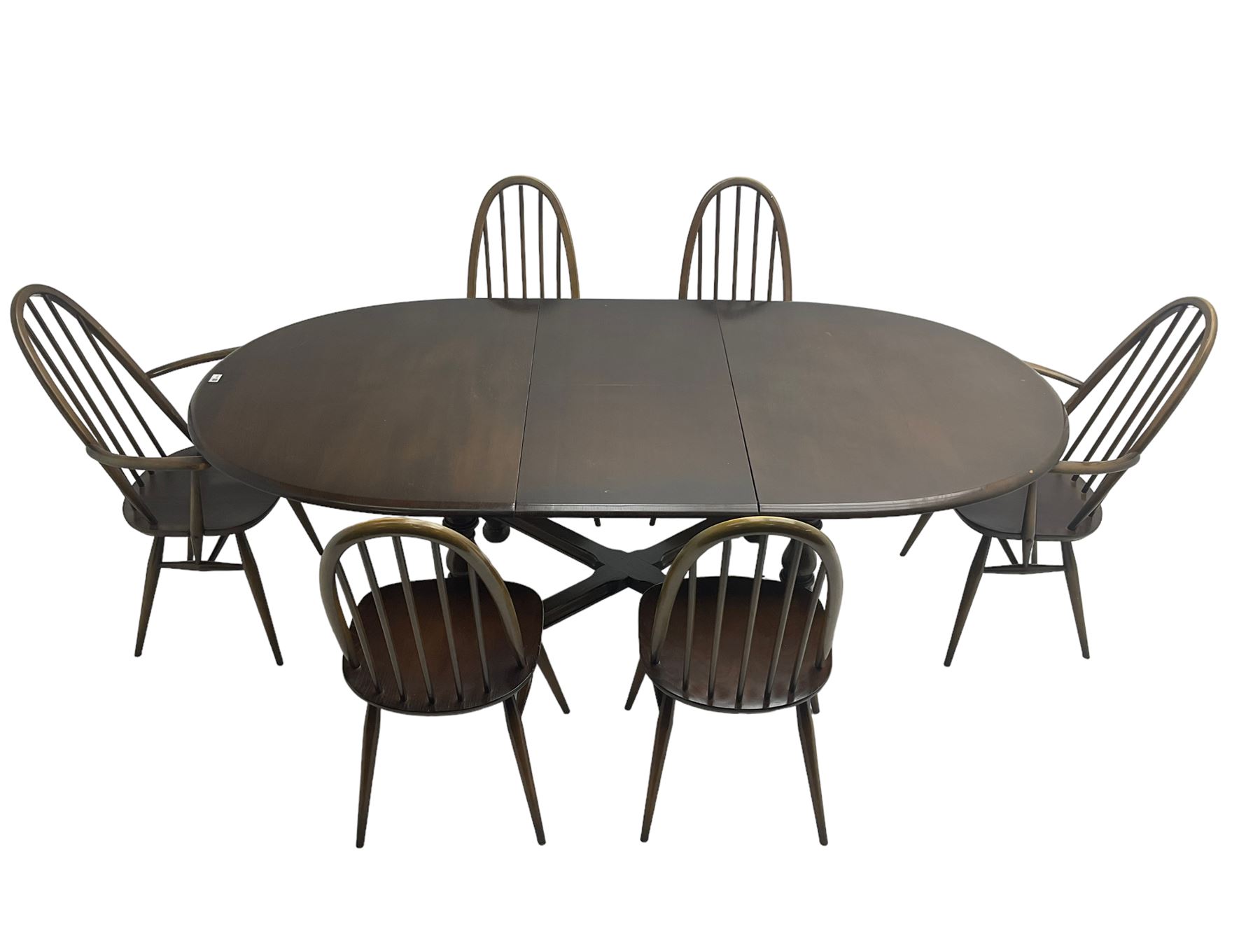 Ercol - 'Old Colonial' 705 elm extending dining table, oval top with hidden leaf, raised on turned supports united by X-stretcher (W163cm D108cm H72cm); and Ercol - set six  (4+2) dark elm 'Quaker Back Windsor Dining Chairs', hoop and stick backs 