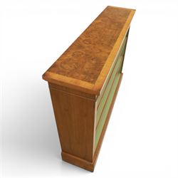 Traditional walnut small bookcase, with projecting cornice above a green painted interior, adjustable shelving, on a moulded plinth base