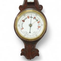 Early 20th-century aneroid barometer with an 8-inch ceramic dial, signed Negretti & Zambra, in a carved oak case, featuring a mercury thermometer