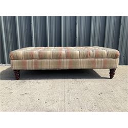 Large rectangular footstool, upholstered in a beige chequered fabric on turned supports