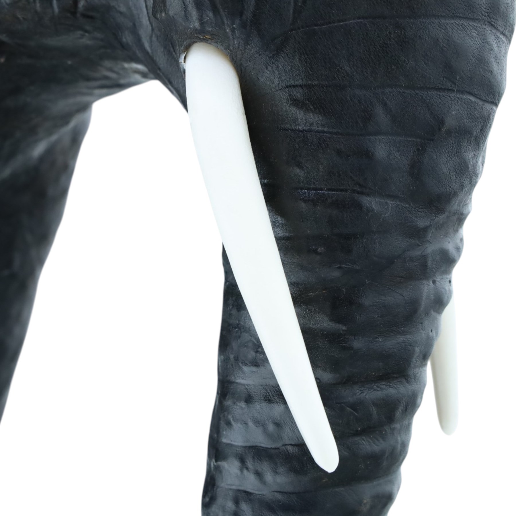In the style of Liberty & Co - pair of 20th century ebonised leather elephants