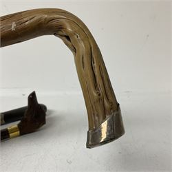 19th century painted bamboo walking cane, the handle carved as a fox with glass eyes, with gilt metal stamped LB, together with an ebonised wooden walking stick, with horn pommel and hallmarked silver collar and a curved wooden walking stick, with monogrammed white metal cap, tallest L90cm