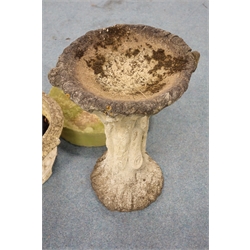  Composite stone tree effect bird bath (H65cm) a composite stone circular tapering planter (D56cm, H28cm) and a mill stone (D55cm)  