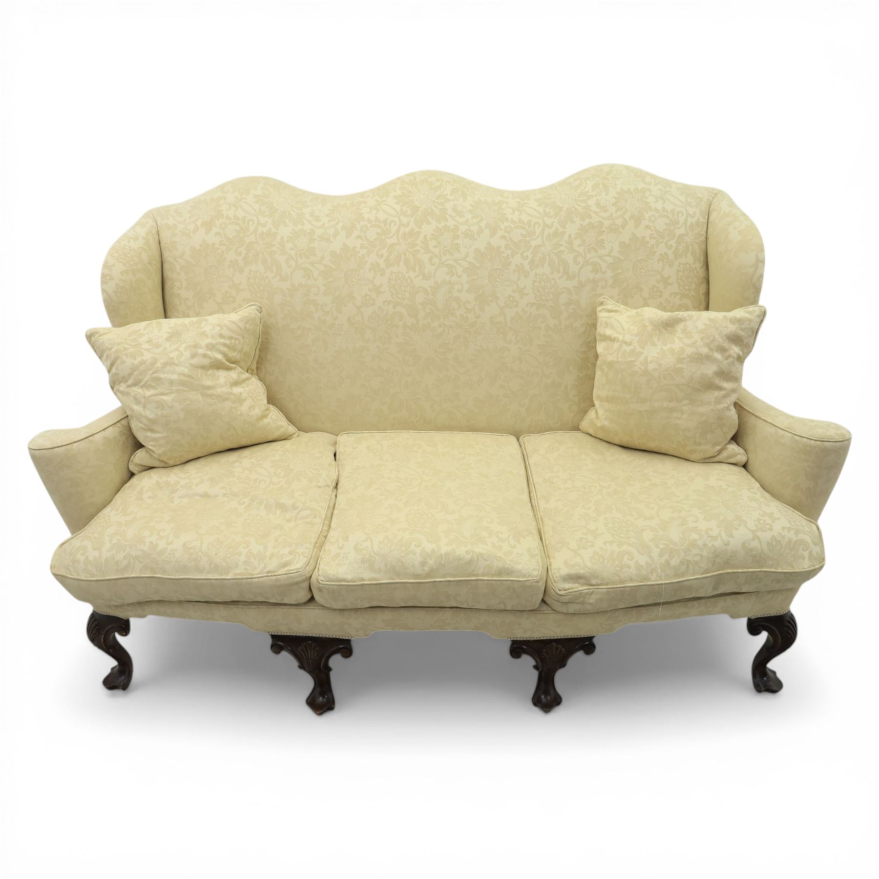 19th century Queen Anne style cream foliate upholstered three seat settee, the shaped and waisted back with serpentine cresting, padded arms over loose seat cushions, raised upon carved cabriole supports with shell carved knees
