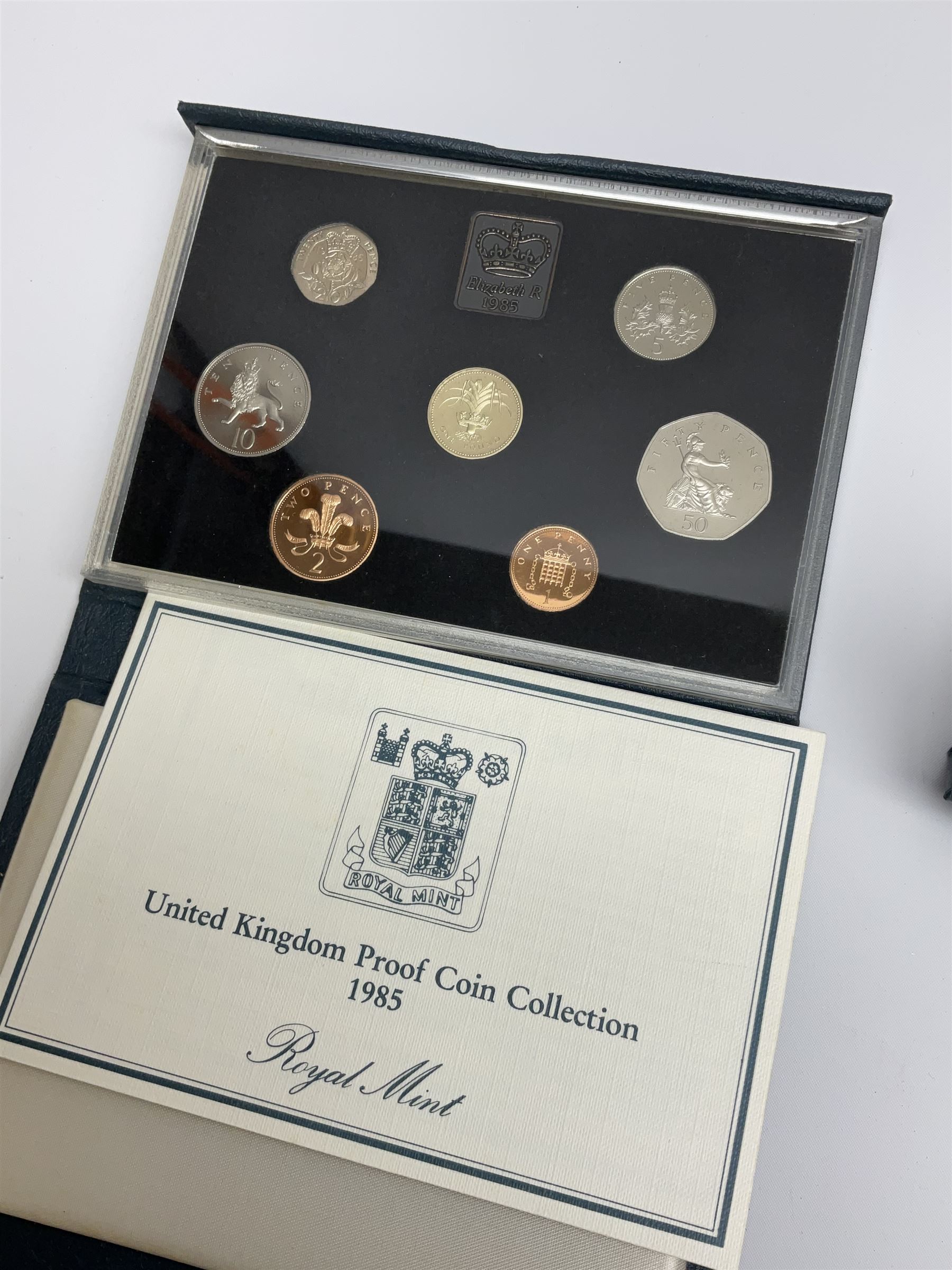 Five Royal Mint United Kingdom proof coin collections dated 1983, 1984, 1985 and 1986, all in blue folders with certificates, silver proof 1981 crown and a sterling silver medal 'Commemorating the marriage of HRH Prince Andrew and Miss Sarah Ferguson at Westminster Abbey 23 July 1986' weighing 37 grams, both cased with certificates (6)