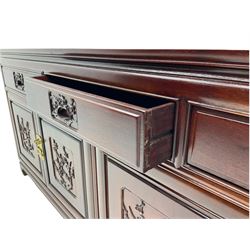 Chinese hardwood sideboard, three drawers above four cupboards, the doors relief carved with flowers and birds 