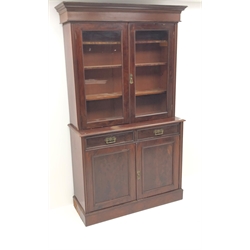  19th century mahogany bookcase on cupboard, two doors enclosing three shelves, two drawers above two cupboards on plinth base, W128cm, H211cm, D43cm  