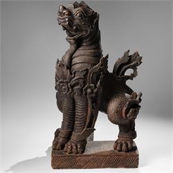 Burmese carved temple guardian figure, depicted seated with carved flame details, H52cm 
