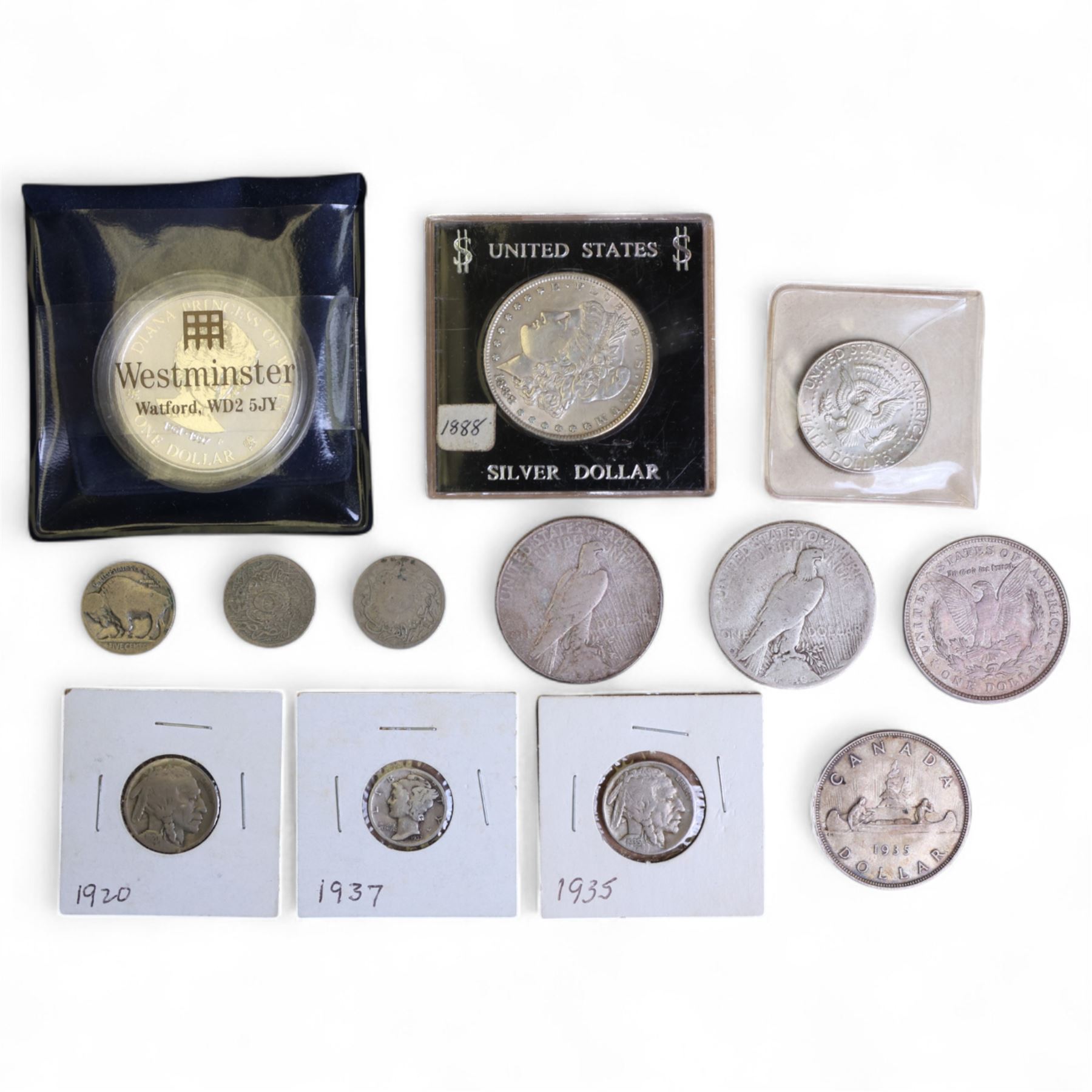 World coins, including four United States of America silver dollars, 1888, 1921, 1922, and 1923, Queen Elizabeth II Cook Islands 1997 fine silver one dollar, King George V Canada 1935 silver dollar, commemorative crowns, etc