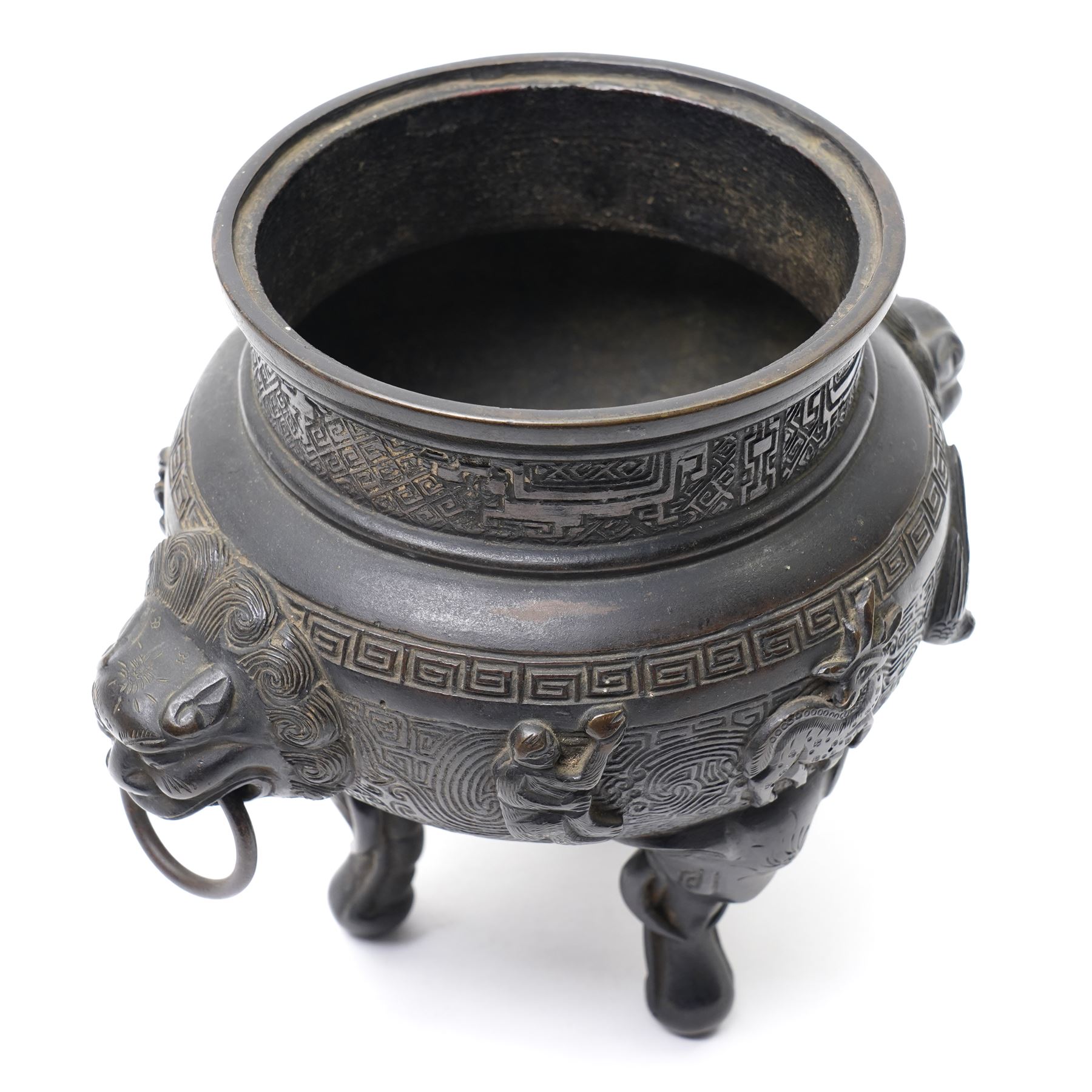 Early 19th century Chinese Qing Dynasty bronze censer, the body of globular form with circular neck and twin cast lion mask ring handles, decorated with applied figures of a monkey, deer and bird, against a key fret detailed ground, the whole upon three zoomorphic elephant feet, H16.4cm D12cm