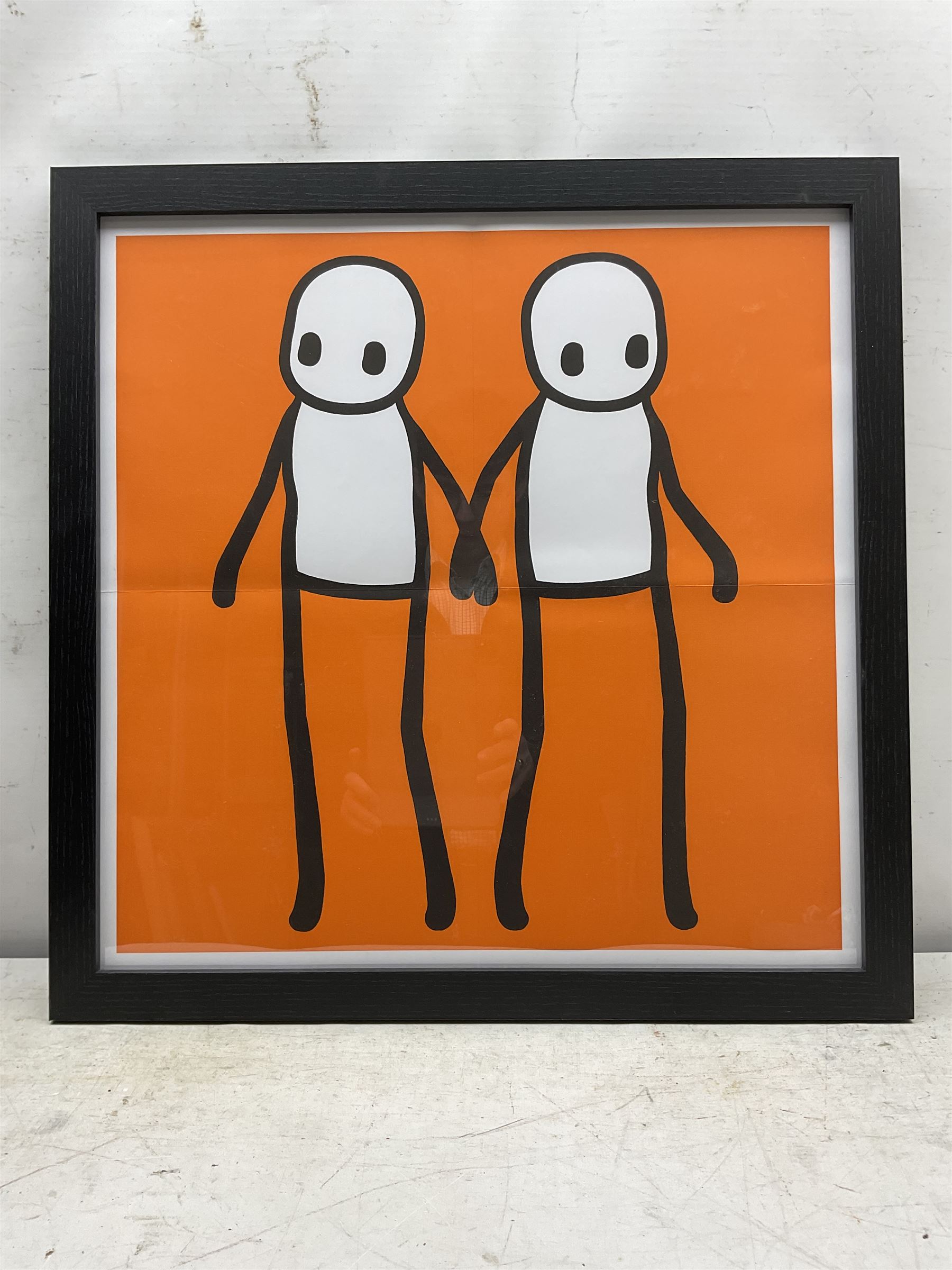 Stik (British 1979-): 'Holding Hands' - Orange, offset lithograph in colours pub. 2020, 49cm x 49cm, together with a copy of 'Hackney Today' newspaper, 21st September 2020, in which the print was distributed (2)