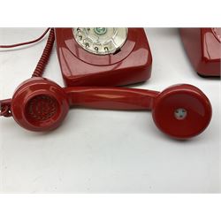 Two mid 19th century red telephones with rotary dials, comprising example marked G.P.O Batch Sampled 8532 706L AEG 67/2A, with junction box marked G.P.O, and another with chrome dial marked P.O Authorised Release 21034 746F EET 78/2