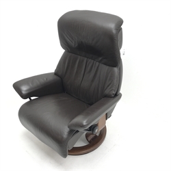 Stressless armchair upholstered in a chocolate leather, shaped support, (W81cm) and a Stressless Ellipse table